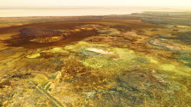 Aerial view of the vibrant yellow and brown mineral deposits of the Dalol geothermal area, showcasing the unique volcanic landscape in Dalol, Afar, Ethiopia.
