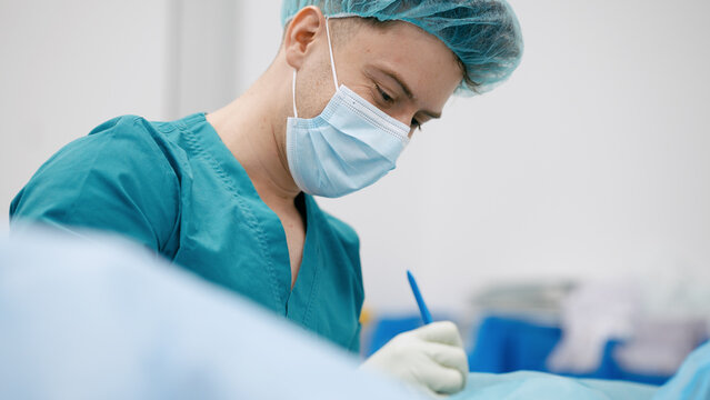 Surgeon preparing for operation, marking skin with a surgical pen. Focus on healthcare, medicine, and precision