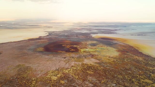 Aerial view of the colorful geothermal landscape with vibrant mineral deposits and volcanic formations in Dalol, Afar, Ethiopia.