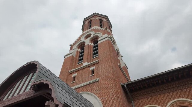 Low angle view of red brick bell tower at Curtea de Arges Monastery in Arges County, Romania