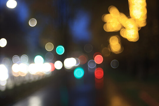Night city blurred background, bokeh in autumn city traffic cars