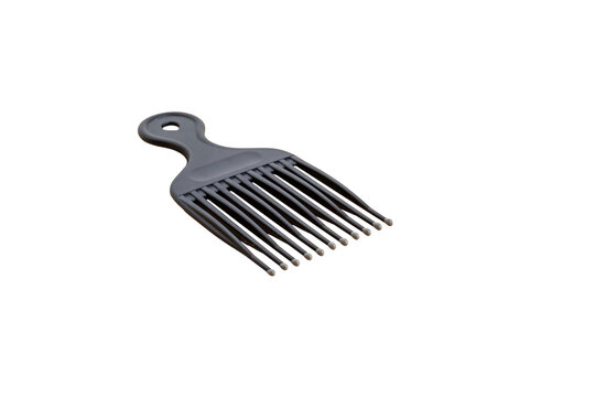 Black hair pick comb lying diagonally on white background