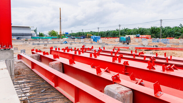 Construction site, pile driving, concrete piles for building construction, industrial factory. Metal beam. Project large site