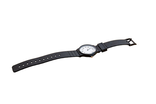 Black rubber strap watch with white face laid diagonally on white background
