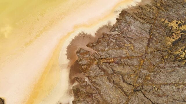 Aerial view of the colorful mineral deposits and rugged rock formations of the Geothermal Area in Dalol, Afar, Ethiopia.
