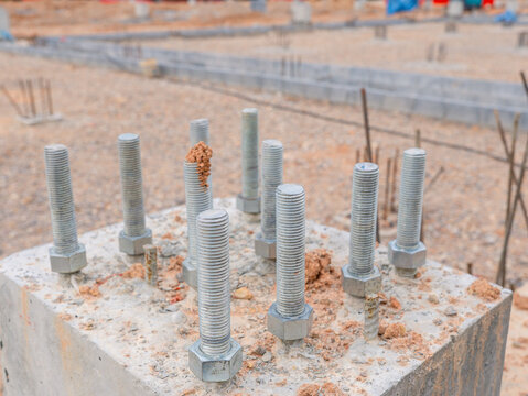 Construction site, pile driving, concrete piles for building construction, industrial factory. Metal beam. Project large site