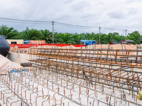 Construction site, pile driving, concrete piles for building construction, industrial factory. Metal beam. Project large site