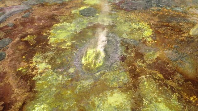 Aerial view of the colorful geothermal area with steaming vents and mineral deposits in Dalol, Afar, Ethiopia.