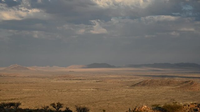Clouds drift over the Namibian desert, African landscape. Timelapse.
