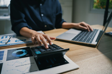 Professional hands calculating finance and business data © amnaj