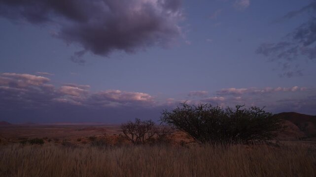 Clouds drift over the Namibian desert, African landscape. Timelapse.
