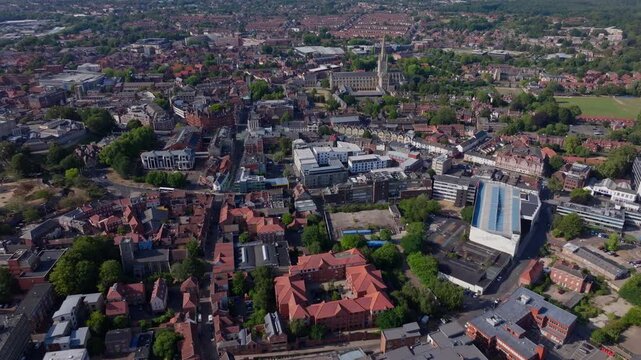 Rising tilt down aerial shot towards Norwich cathedral