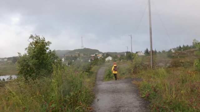Mother with three kids and a pet dog, hiking Munkebu in extremely bad weather, fog and rain, andventure hiking in nature in Lofoten, Norway