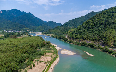 Fototapeta premium Scenic River Valley with Lush Greenery