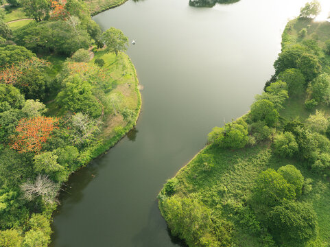 Aerial view of calm freshwater lake surrounded by tropical greenery. Water sustainability, natural ecosystems, biodiversity conservation. Sustainable water resources, biodiversity, ecosystem health.