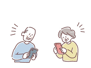 Fototapeta premium スマートフォンを見て驚く高齢者の男女 