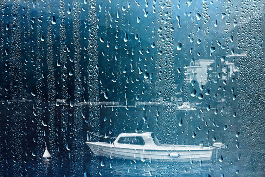 Wet glass with droplets, autumn rain as the background, an autumn mood.