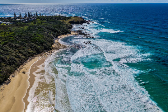 Aerial view of clear turquoise ocean water and rugged rocky coastline at Brooms Head, showcasing the natural coastal landscape and distinctive rock formations along the Clarence Valley coastline