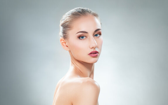Elegant Woman with Flawless Skin and Natural Makeup in Studio Portrait