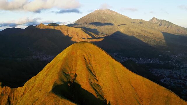 Aerial view of majestic mount rinjani and pergasingan hill at sunrise in sembalun lombok island indonesia.