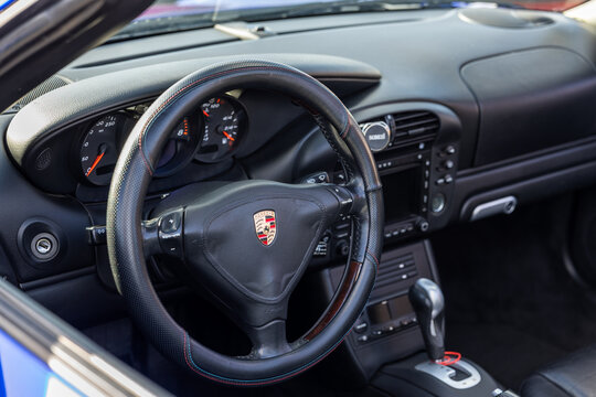 Close-up of a Porsche car interior with steering wheel, dashboard and gear selector in Kaliningrad, Russia. August 23, 2026