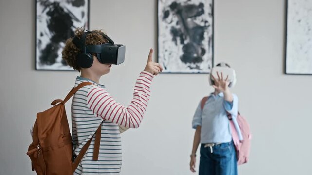 Caucasian children wearing virtual reality headsets gesturing in art gallery. Ideal for promoting educational technology, interactive museum tours, and digital learning experiences