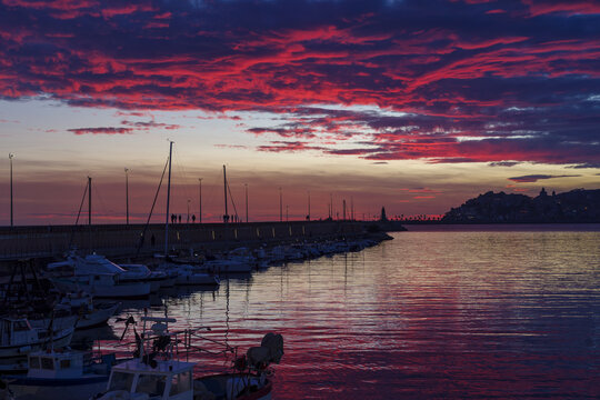 Sunset silhouette Imperia coastal city, Italy