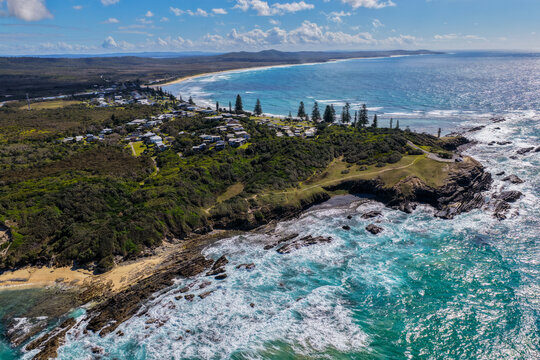 Aerial view of clear turquoise ocean water and rugged rocky coastline at Brooms Head, showcasing the natural coastal landscape and distinctive rock formations along the Clarence Valley 