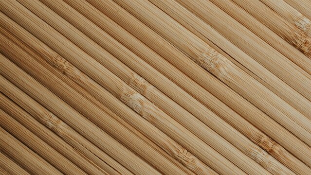 Natural bamboo sticks texture background, diagonal wooden reed pattern for spa and wellness design, organic tan wood slat surface, eco-friendly material backdrop.