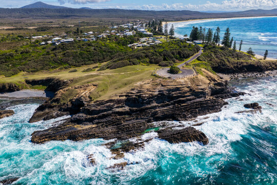 Aerial view of clear turquoise ocean water and rugged rocky coastline at Brooms Head, showcasing the natural coastal landscape and distinctive rock formations along the Clarence Valley 