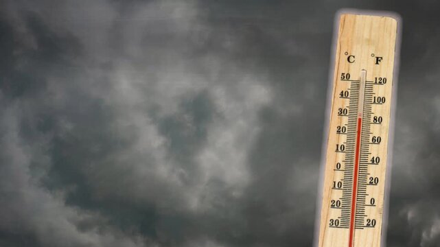 Thermometer with high temperature against the background of pitch black sky and lightning strikes. Storm concept. Extreme weather. Weather changes. Effects of global warming	