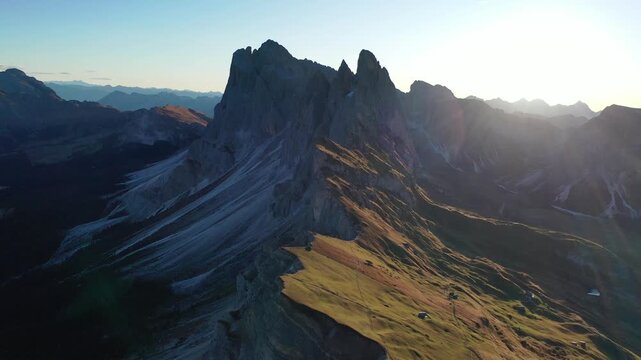 Aerial view of Seceda mountain peak at sunrise in the Italian Dolomites.