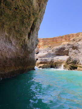 Turquoise water pool in narrow canyon with limestone rock walls