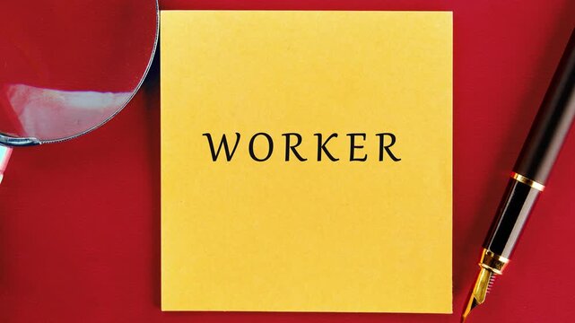 The word worker is printed on a yellow sticky note with a magnifying glass and pen