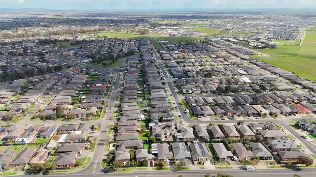 Aerial high-angle view of uniformly planned residential housing estates and grid-like suburban streets in Wyndham Vale, Melbourne, Australia. Geometric street grids and rectangular allotment divisions