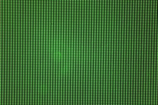 Green LED screen overlay, pixel matrix structure macro view on computer monitor display showing
