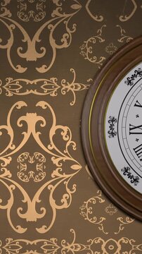 Animation of retro clock ticking showing midnight with gold patter on brown background