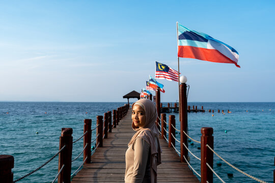 Young beautiful woman and Malaysian and Sabah state flag