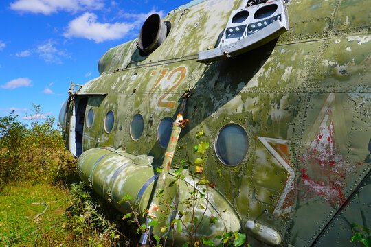 The rusty nose of the Mi-8 helicopter. The green front of a military helicopter with broken windows and