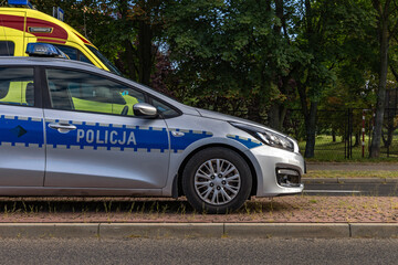Polish Police Car and Ambulance Parked at Roadside © dominikspalek.pl