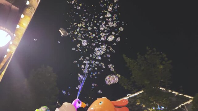 Colorful Carnival Toys and Floating Soap Bubbles at Night Fairground