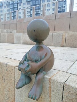 The Hague. Holland. bronze sculpture "Lonely child" (nid. SprookjesBeelden aan Zee). part of the "Sculptures by the Sea" collection in Scheveningen, the Netherlands.