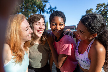 Obraz premium Joyful diverse friends bonding outdoors.