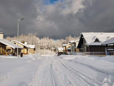Snow-covered, uncleared road in a siberian cottage village.