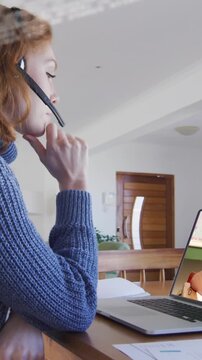 Animation of data processing over businesswoman using laptop