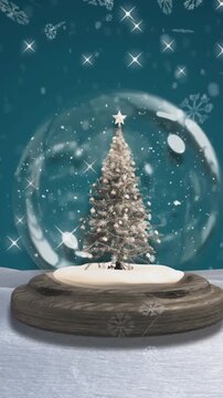 Snowflakes falling over christmas tree in a snow globe against blue background
