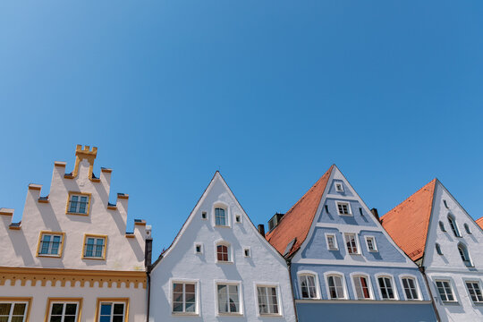 Row of historic gabled house facades under clear blue sky in Landsberg am Lech, traditional Bavarian architecture concept