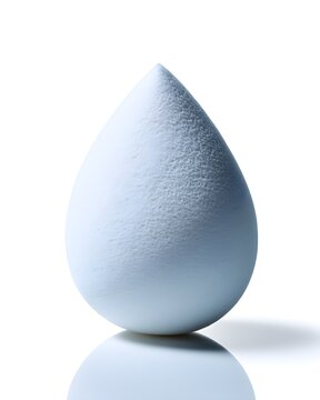 White silicone makeup blending sponge with teardrop shape, beauty tool isolated on white background