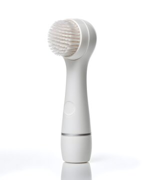 White silicone facial cleansing brush with fine bristles, beauty tool isolated on white background