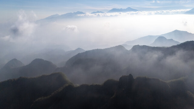 Aerial view of Gunung Kelud with misty mountain peaks and clouds in the volcanic landscape of Kecamatan Ngancar, Jawa Timur, Indonesia.